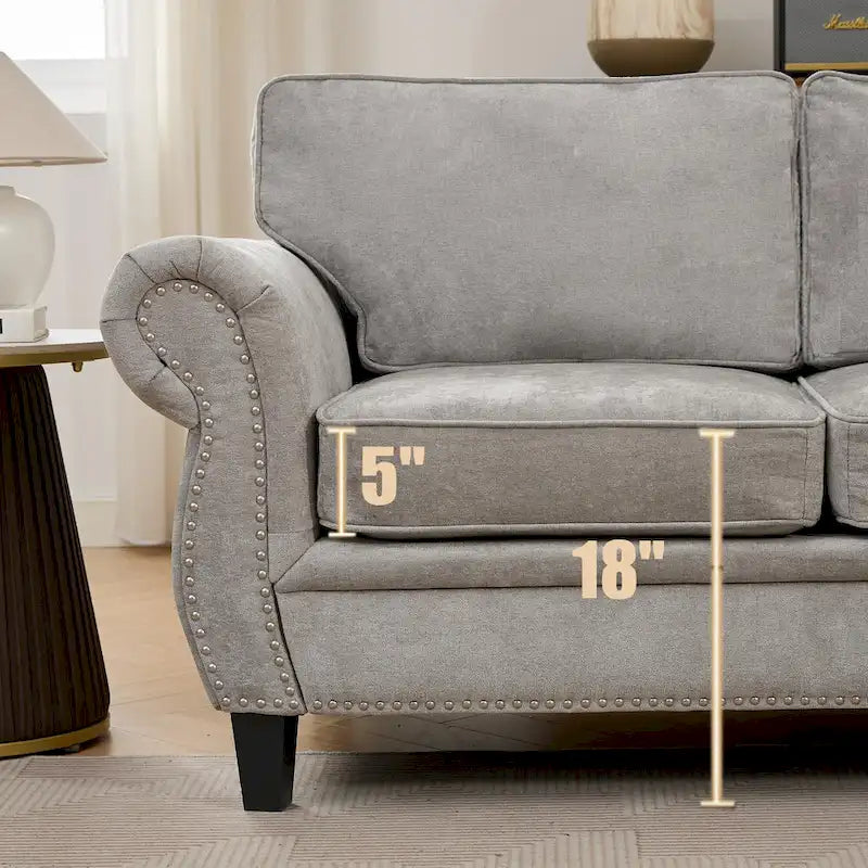 Canapé d'angle 6 places en chenille avec accoudoirs roulés décorés de rivets